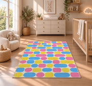 Pastel Pill Pattern area rug in a nursery beside a crib