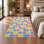 Pastel Pill Pattern area rug in a bedroom beside the bed