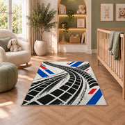 Tire Track Pattern police rug in a nursery with a crib and armchair
