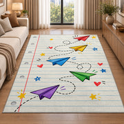 Paper Planes on Notebook Paper area rug in a living room beside a sofa