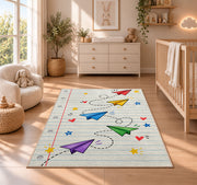 Paper Planes on Notebook Paper area rug in a nursery beside a crib