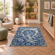 Blue and White Porcelain Tiger tiger rug in a nursery with a crib and armchair