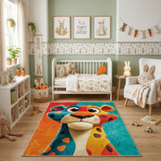 Colorful geometric giraffe rug shown beside a child’s bed