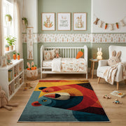 Colorful geometric toucan rug shown beside a child's bed