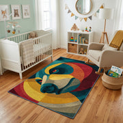 Colorful geometric chameleon rug styled with soft nursery decor