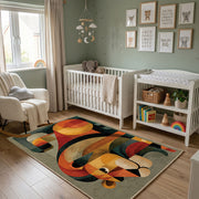 Colorful geometric toucan rug wide room view in a modern nursery