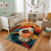 Colorful geometric owl rug styled with soft nursery decor
