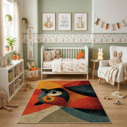Colorful geometric woodland animal rug shown beside a child's bed