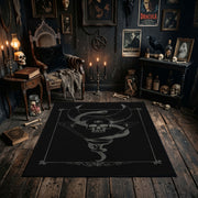 Minimal Serpent Skull Sigil Area Rug shown in a candlelit dark room