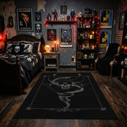 Minimal Serpent Skull Sigil Area Rug displayed beneath framed wall art