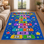 Multiplication Hopscotch Rug shown beside a sofa in a bright living room
