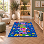 Multiplication Hopscotch Rug shown in a nursery with a cot and soft toys