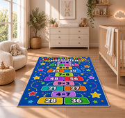 Multiplication Hopscotch Rug shown in a sunlit nursery beside a white cot
