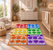 Rainbow Shapes Color Chart Rug shown in a sunlit nursery beside a white cot