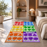 Rainbow Shapes Color Chart Rug shown in a bedroom by a garden window