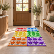 Rainbow Shapes Color Chart Rug shown in an entryway near a wooden door