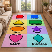 Pastel Shapes Learning Rug shown beside a sofa in a bright living room
