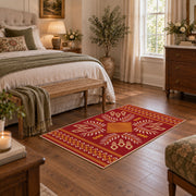 red and gold folk art floral pattern area rug, cozy home setting