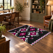 black and magenta tribal diamond pattern area rug, wood floor styling