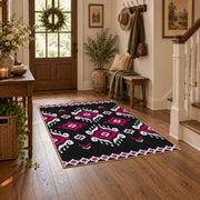 black and magenta tribal diamond pattern area rug, close decorative detail