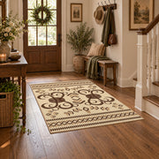 cream and brown ornamental scroll pattern area rug, close decorative detail