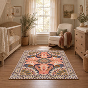 coral and blue decorative elephant and paisley motif area rug, warm living room view