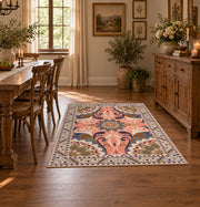 coral and blue decorative elephant and paisley motif area rug, close decorative detail