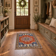 burnt orange and blue floral medallion pattern area rug, warm living room view