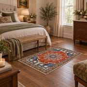 burnt orange and blue floral medallion pattern area rug, cozy home setting