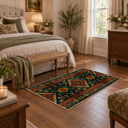 dark teal and orange tribal geometric pattern area rug, cozy home setting