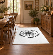 white wander compass hiking quote area rug, close decorative detail