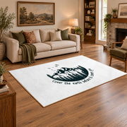 white cover the earth mountain quote area rug, angled room view