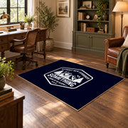 navy white mountain adventure badge area rug, wood floor styling