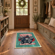 Motorcycle repair graphic area rug in teal, red, black, and cream, wide interior view