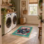 Motorcycle repair graphic area rug in teal, red, black, and cream, design detail view