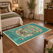 Hunting and fishing emblem area rug in teal, cream, brown, and black, full pattern view