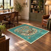 Hunting and fishing emblem area rug in teal, cream, brown, and black, soft surface detail