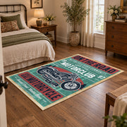 Vintage motorcycle graphic area rug in teal, red, cream, and black, soft surface detail