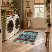Vintage motorcycle graphic area rug in teal, red, cream, and black, wide interior view