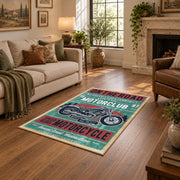 Vintage motorcycle graphic area rug in teal, red, cream, and black, design detail view