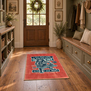 Skull mechanic workshop area rug in red, teal, cream, and black, featured room view