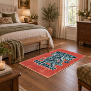 Skull mechanic workshop area rug in red, teal, cream, and black, cozy home setting