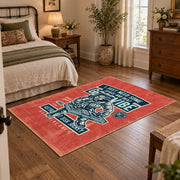 Skull mechanic workshop area rug in red, teal, cream, and black, soft surface detail