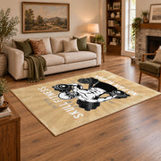 Vintage bodybuilding area rug in beige, black, white, and gold, angled room view
