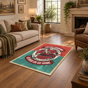 Soccer player emblem area rug in red, teal, cream, and black, cozy home setting