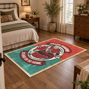 Soccer player emblem area rug in red, teal, cream, and black, soft surface detail