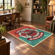 Soccer player emblem area rug in red, teal, cream, and black, wood floor styling