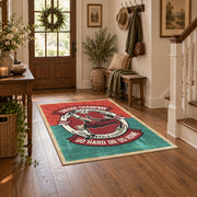 Soccer player emblem area rug in red, teal, cream, and black, close decorative detail