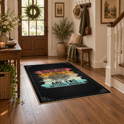 Knitting yarn quote area rug in black with coral, teal, yellow, and cream accents, wood floor styling