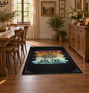 Knitting yarn quote area rug in black with coral, teal, yellow, and cream accents, close decorative detail